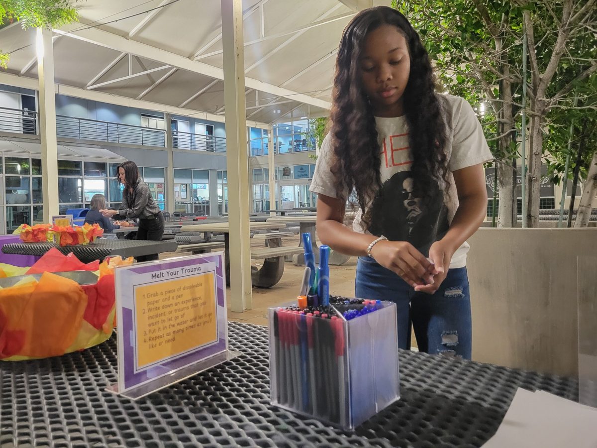 Office of Equity and Compliance Student Assistant Kijana Brown organizes markers and pens at the 'Melt Your Trauma' table outside of the Campus Store Complex at CSUN in Northridge, Calif. on Oct. 28, 2025.
