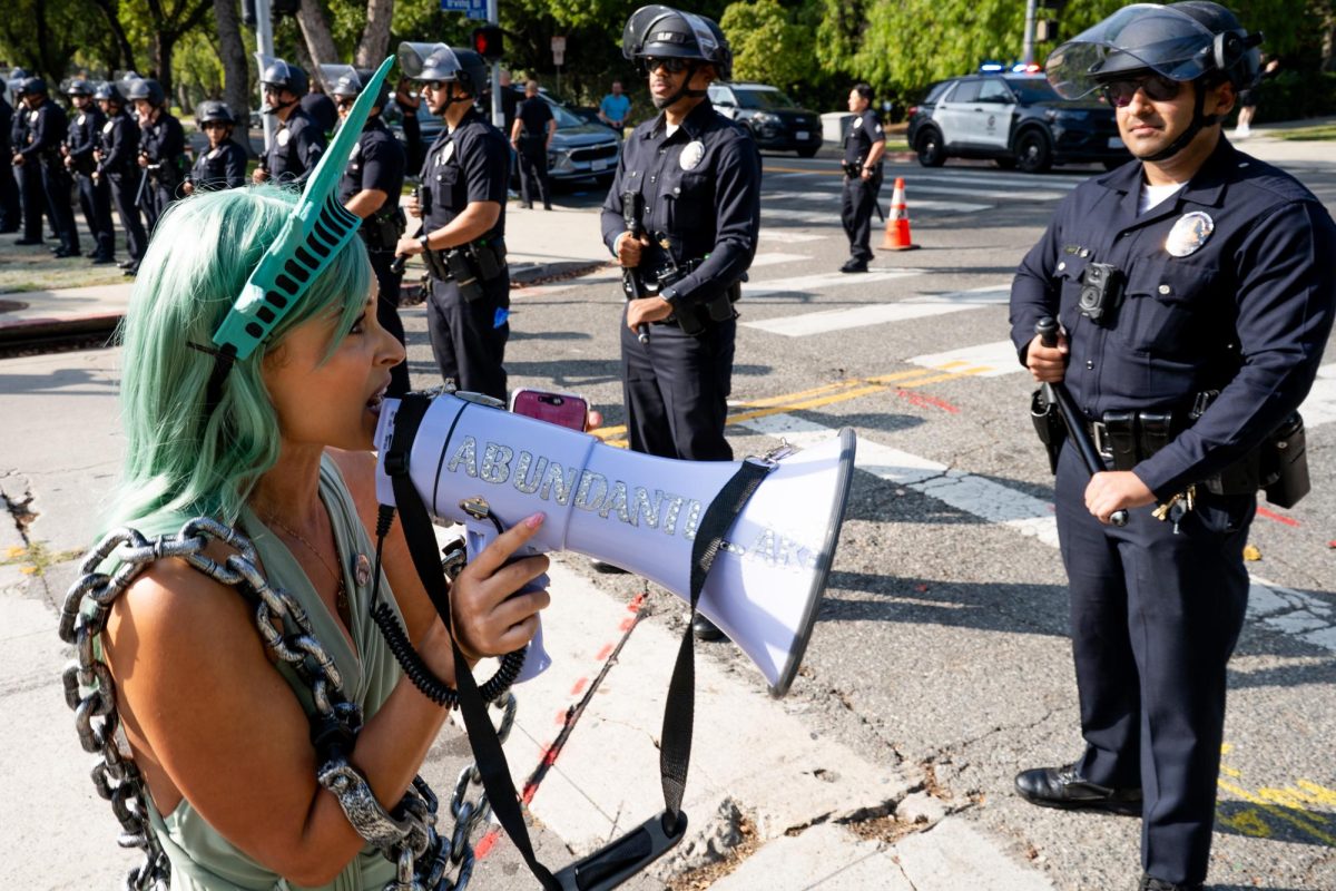 LAPD officers form a line on the street of Mayor Karen Bass' residence on Oct. 26, 2025. Protesters believed the mayor was home at the time based on the cars in the driveway, but only her security guards were seen outside the house.
