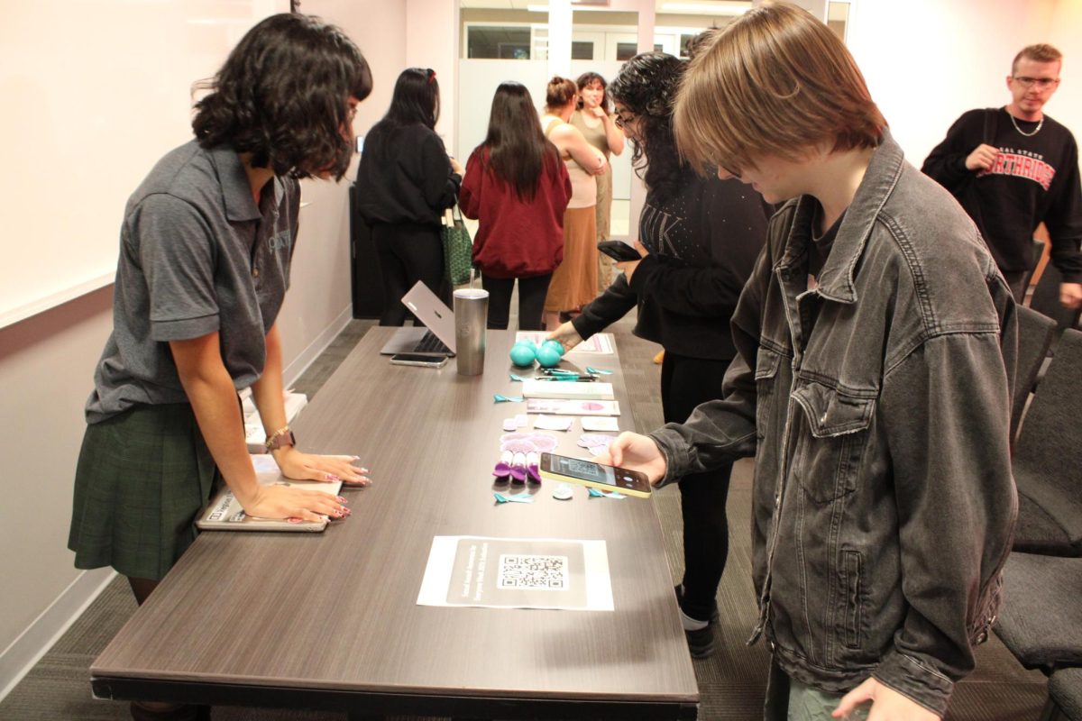 Students scan a QR code provided by peer educator Jay Guillen after the What is Rape Culture workshop at the CSUN East Conference Center in the University Student Union on Oct. 22. The program is one of three sponsored by the University Counseling Services, offering students separate resources and a safe space for anyone who has been a victim of sexual assault on campus. 