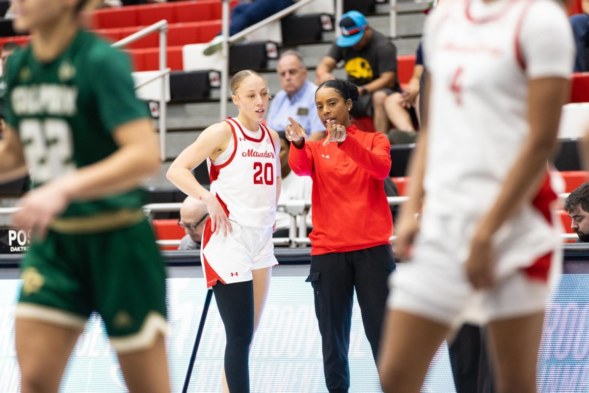 CSUN guard Erica Adams, 20, talks with Head Coach Angie Ned while a teammate shoots free throws during the game against Cal Poly on Saturday, Dec. 7, 2024, at the Premier America Credit Union Arena in Northridge, Calif.