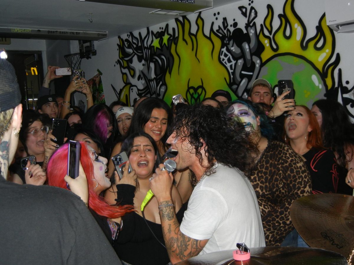 Cole Hutzler, lead singer of Beauty School Dropout sings to the crowd at Hazheart in Van Nuys, Calif. on Nov. 4, 2025. The band played a pop-up show following the end of their tour supporting punk band Letlive.