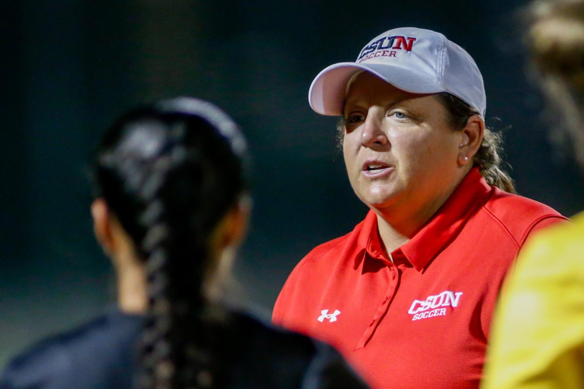 Coach Gina Brewer speaks to players after a game against Grand Canyon University on Aug. 21, 2025.