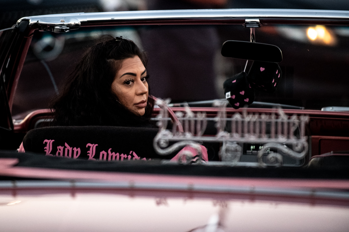 A woman looks back as she drives her lowrider during a Hollywood cruise get together on Nov. 29, 2025.