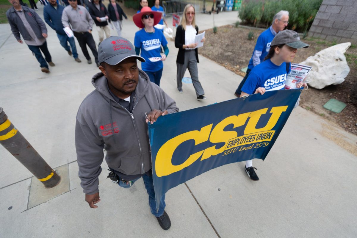 CSUN faculty members march during a rally to protest CSU administrators receiving higher wage raises at CSUN in Northridge, Calif., on Jan. 21. 2026.