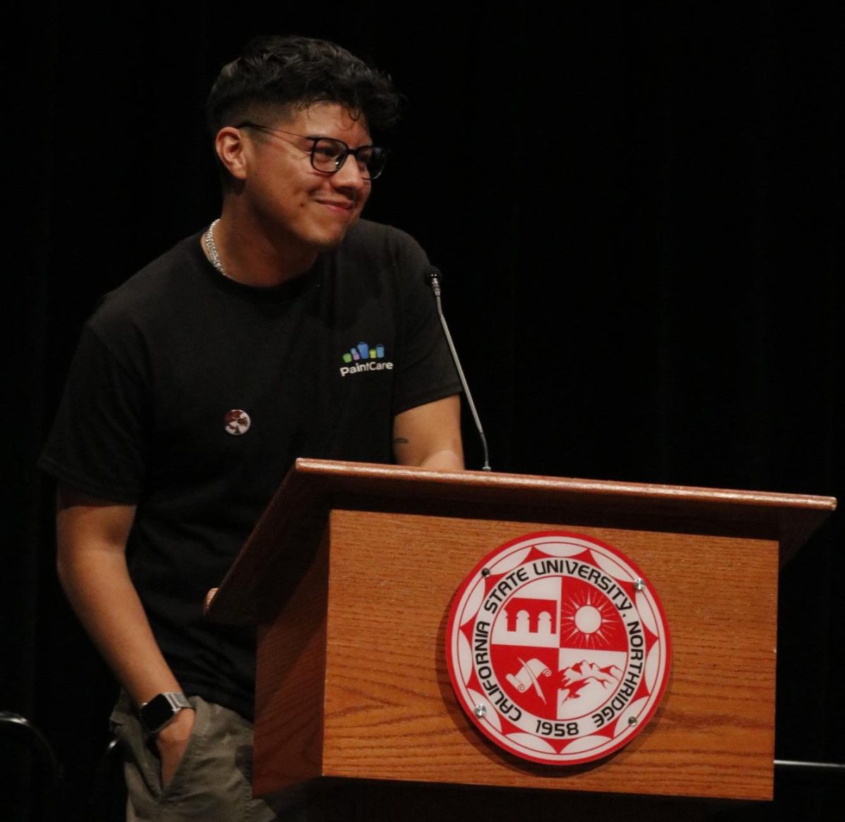 Health and Human Development Senator Eddie Umana stands at the podium delivering his Meet the Candidates speech at Northridge Center in Northridge, Calif. on March 27, 2025.