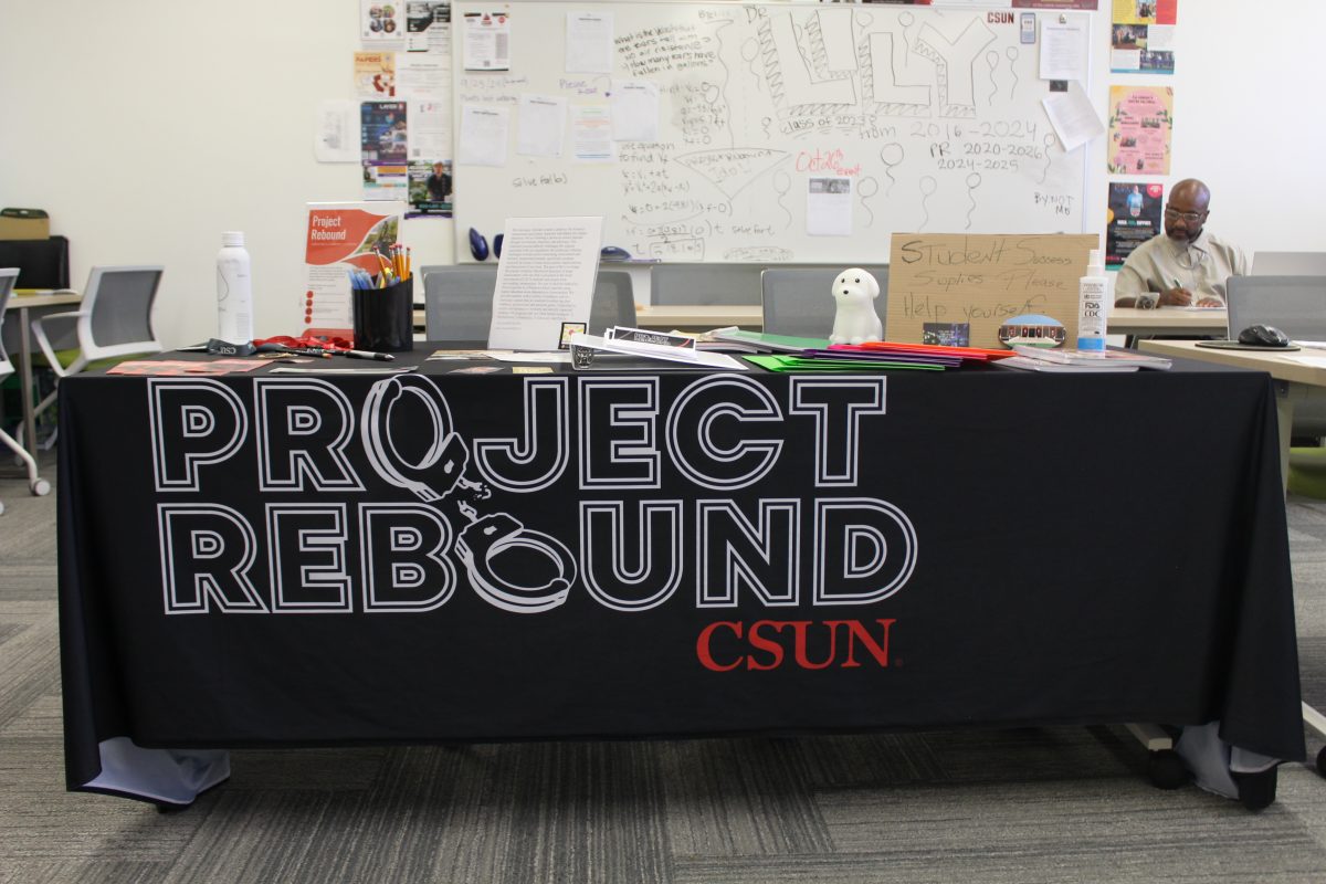 Information desk at Project Rebound’s room with member Timmy Tyson in the background. 