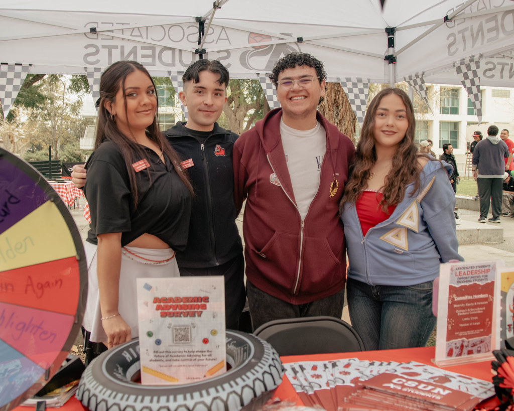 (From left) Chair Araceli Torres, Assistant Chair Tommy Nuno, Senate Representative Richie Quiroga and Elections Committee Member Joana table for the AS Elections Kickoff event on Feb. 10 during the Farmers Market. 
