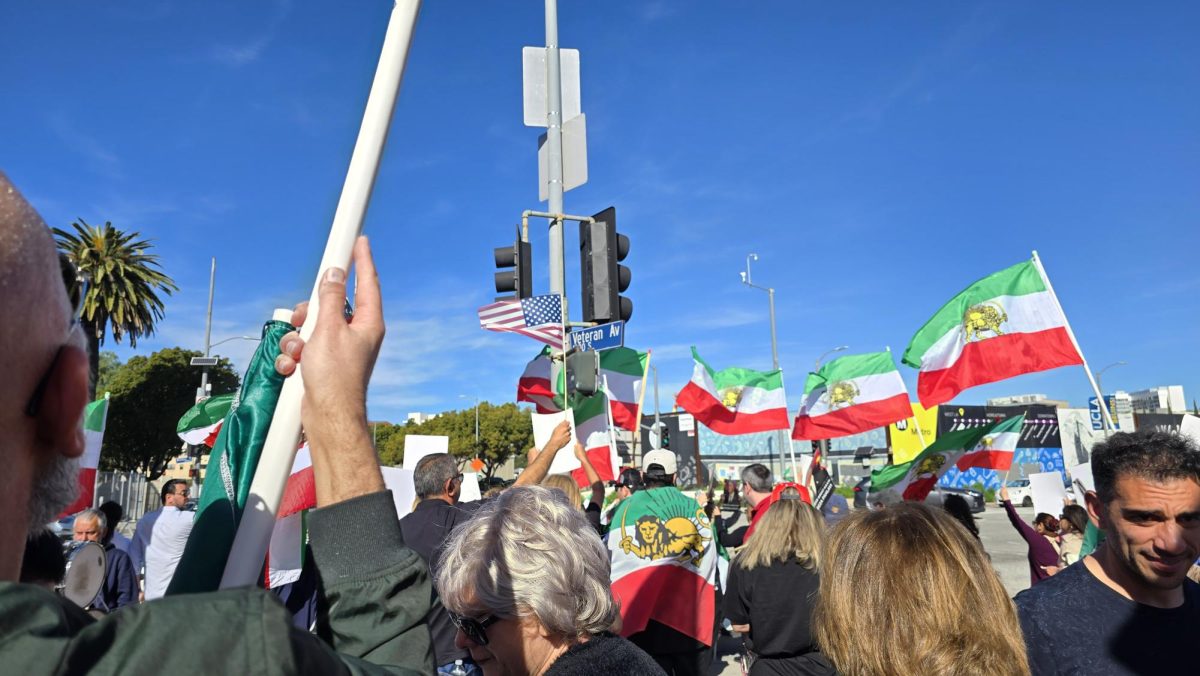 Iranian protesters wave pre-revolution Iranian flags and American flags during a demonstration in Westwood, Calif. on Jan. 11, 2026.