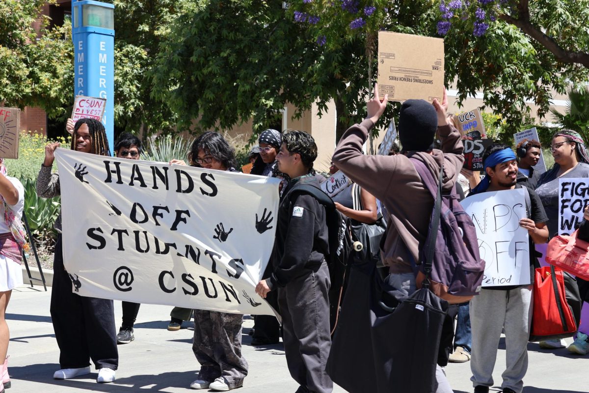 Students holding a sheet with "Hands off Students @ CSUN" at the Hands Off Students rally at California State University, Northridge, on April 23, 2026, in Northridge, Calif.
