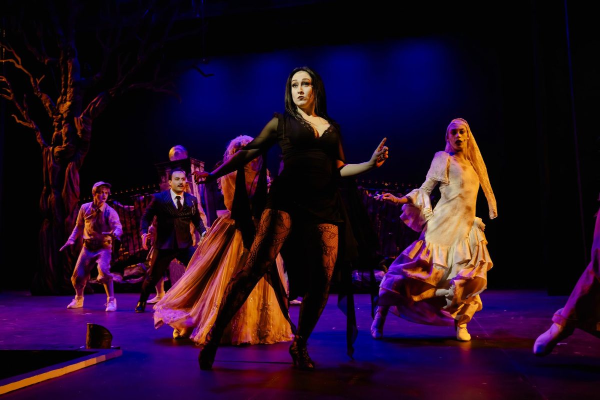 Hanna Brown as Morticia Addams (center), Trinidad James Sandoval (far left), and the ensemble as the ancestors doing the tango in the dance number "Live Before We Die/Tango De Amor," in "The Addams Family Musical."