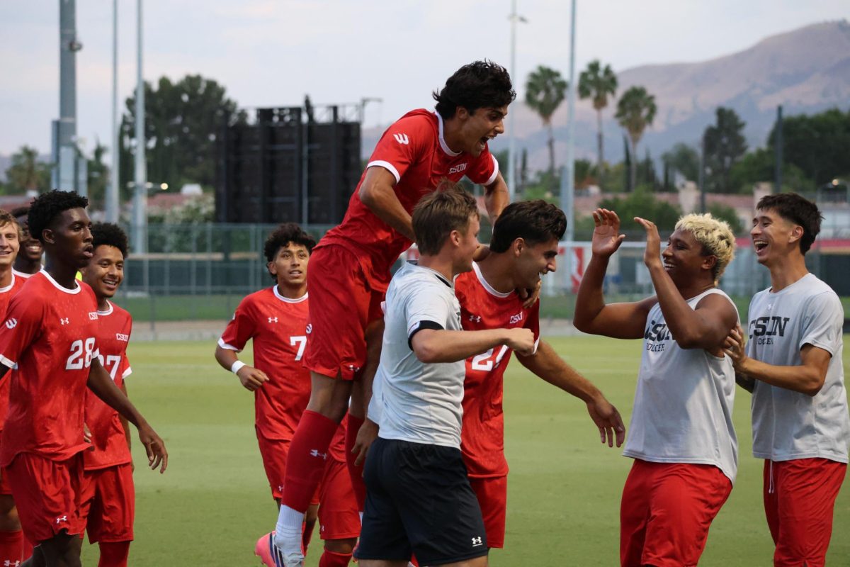 The team celebrates with CSUN forward Kayvon Monfared after he scores the first goal of the season at Matador Soccer Field on Aug. 28, 2026, in Northridge, Calif.