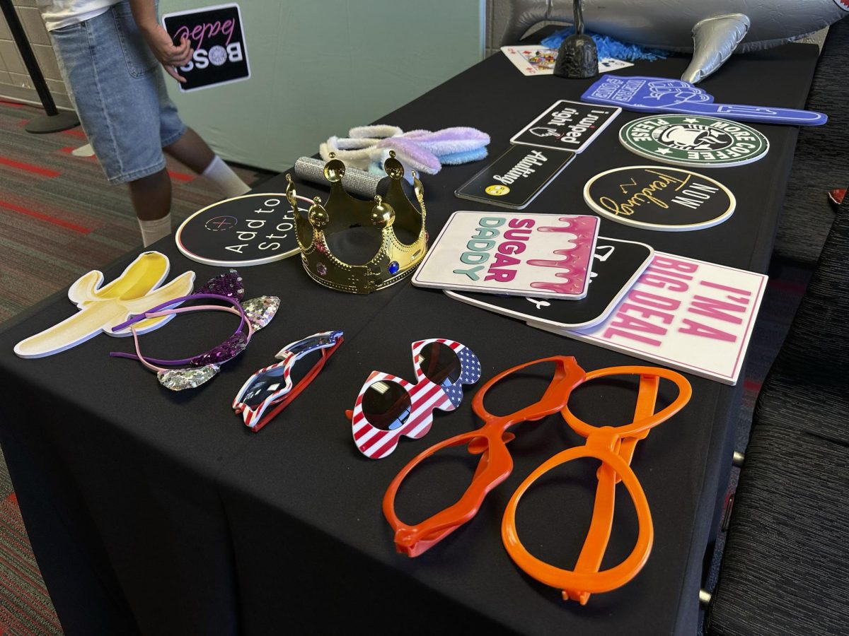 A student grabs a photobooth sign from Photobooth Geeks to take a picture at the USU Northridge Center for Matafest on Aug. 26, 2026.