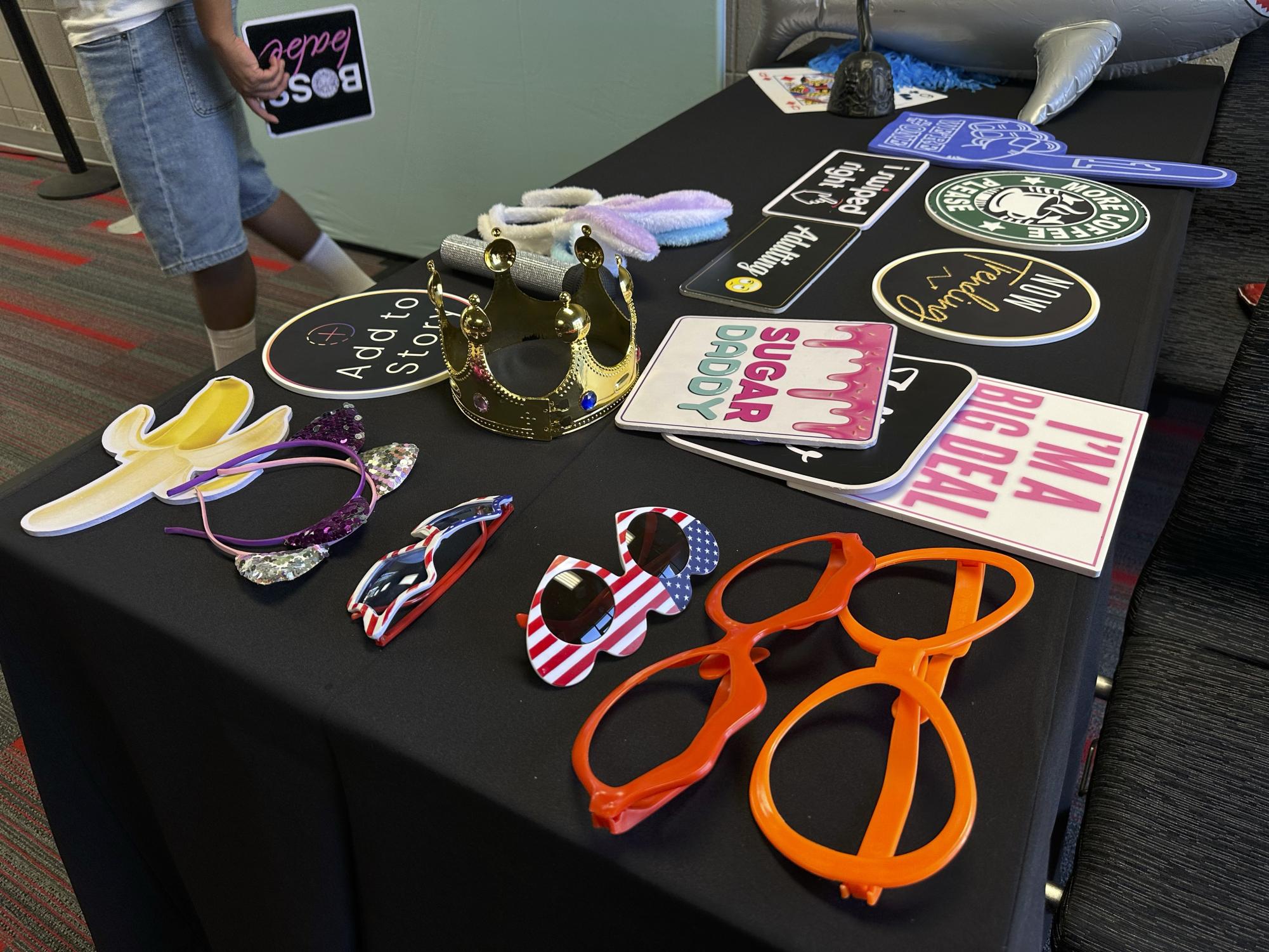 A student grabs a photobooth sign from Photobooth Geeks to take a picture at the USU Northridge Center for Matafest on Aug. 26, 2026.