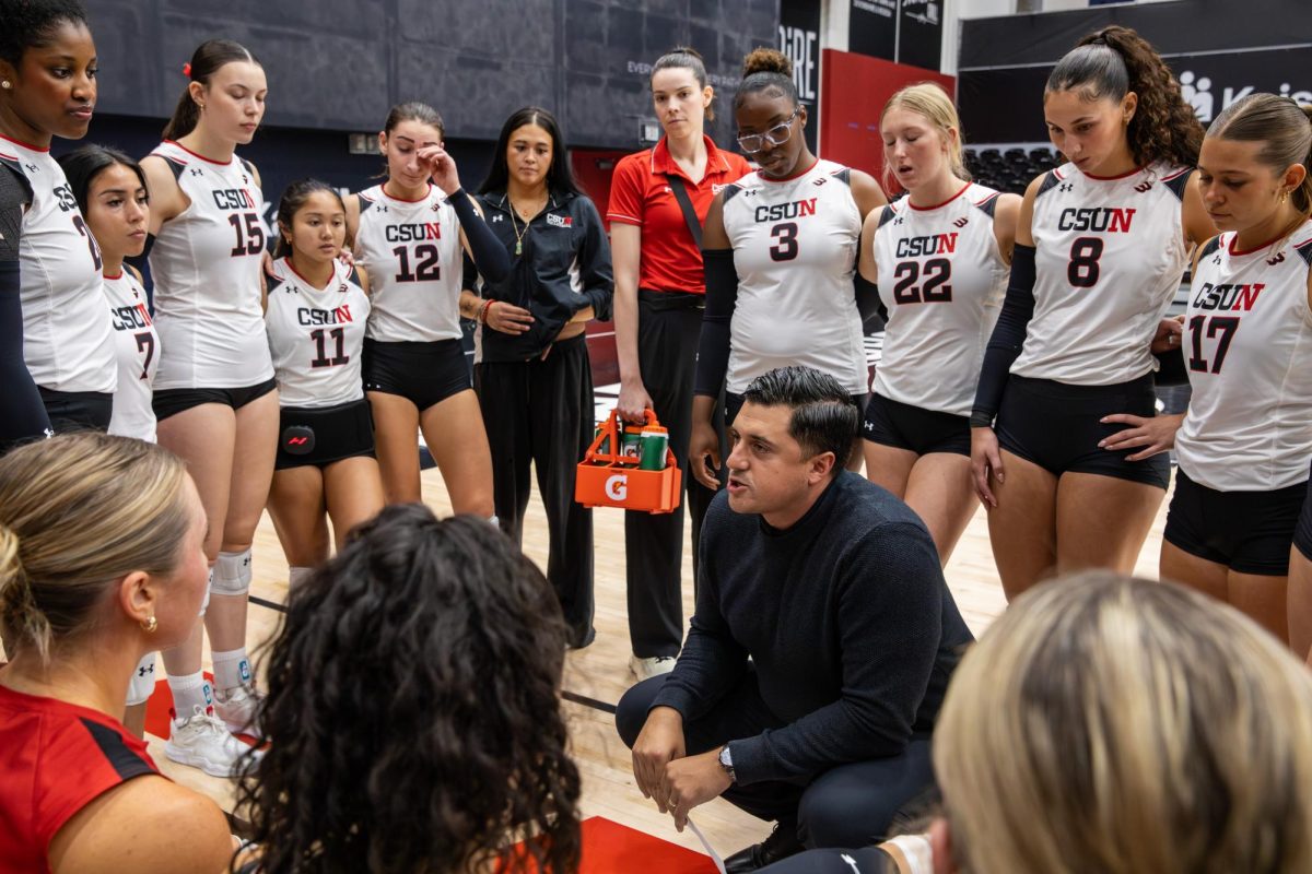 Head coach Aquiles Montoya speaks with the players during a timeout during the CSUN vs LMU women's volleyball game on Saturday, September 19, 2026, in Northridge, CA. The game ended 3-2 with LMU taking the win.