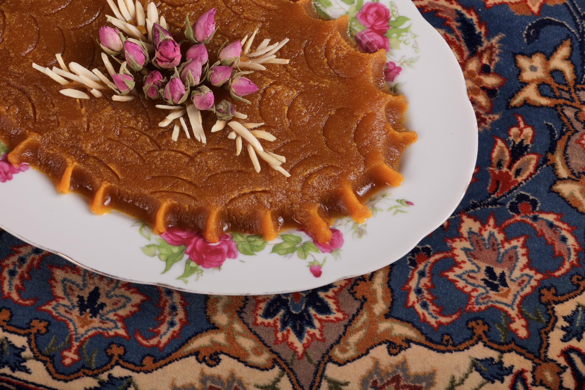 Iranian Halva, Halwa in carpet background. Photo by Roshanaei via Adobe Stock.