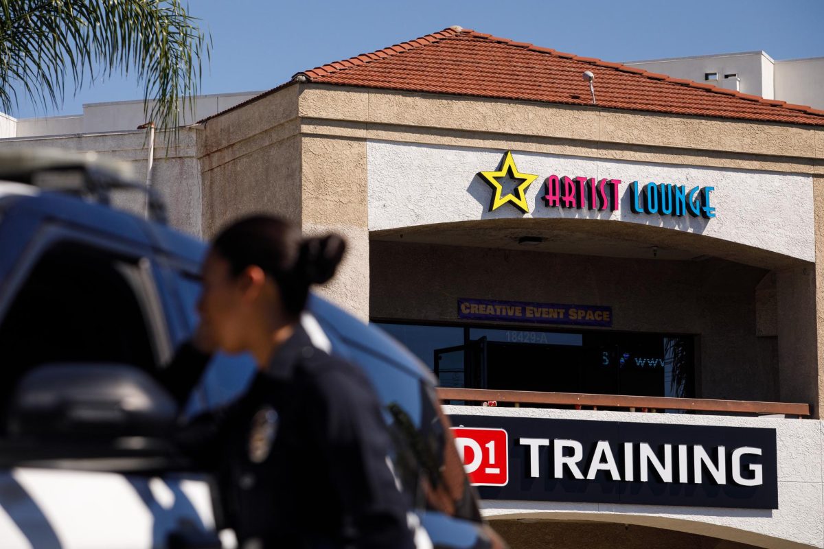 LAPD Officer Lopez speaks with another officer at the scene after a shooting at the Artist Lounge late last night in Northridge, Calif., on Saturday, Oct. 3, 2026.