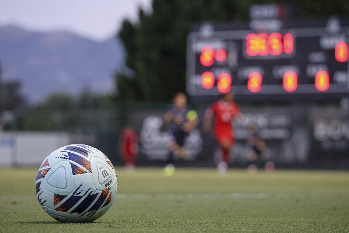 A soccer ball rests near the sideline as the match continues behind it at Matador Soccer Field on Aug. 28, 2026, in Northridge, Calif.