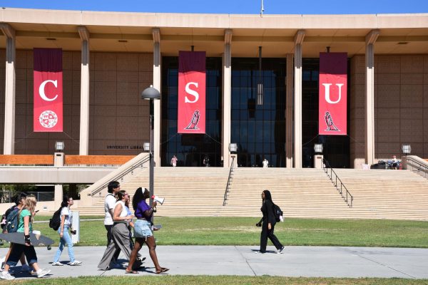 Attendees march in front of the University Library in support of the Stand Together Against Sexual Violence walkout on Thursday, Oct. 8, 2026.