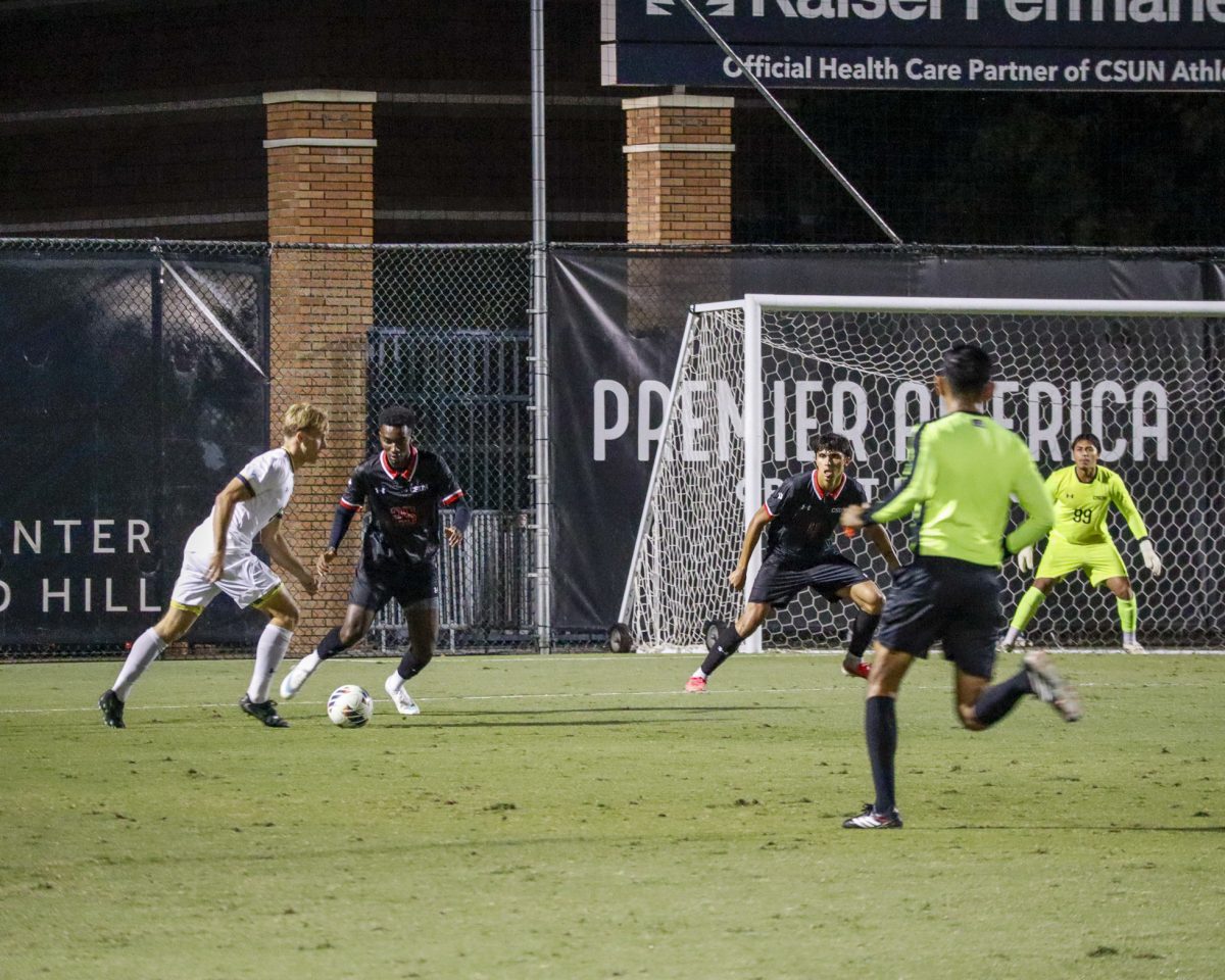 California State University, Northridge defenders Abdallah Traore (left) and Daniel Garcia (center) defend against a University of California, San Diego player during a men's soccer match at Matador Soccer Field in Northridge, Calif., on Wednesday, Oct. 21, 2026.